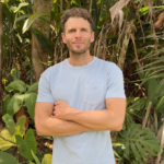 Codie See stands with his arms crossed