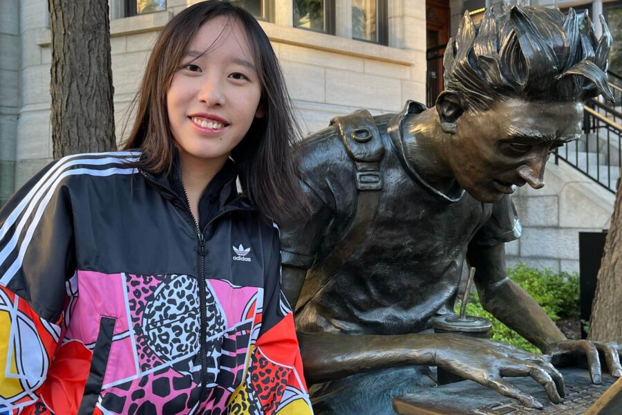Yanbing poses with a statue