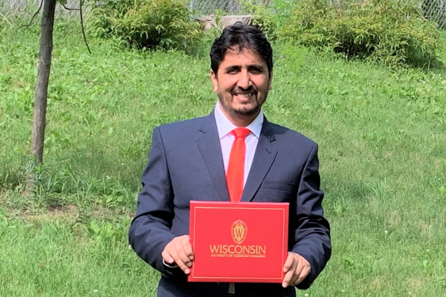 Abdullah Ameen poses with his diploma during his COVID-era graduation