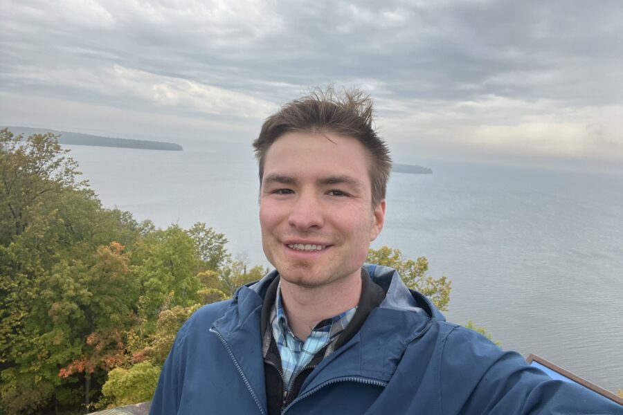 Jack Plasterer stands at a shoreline