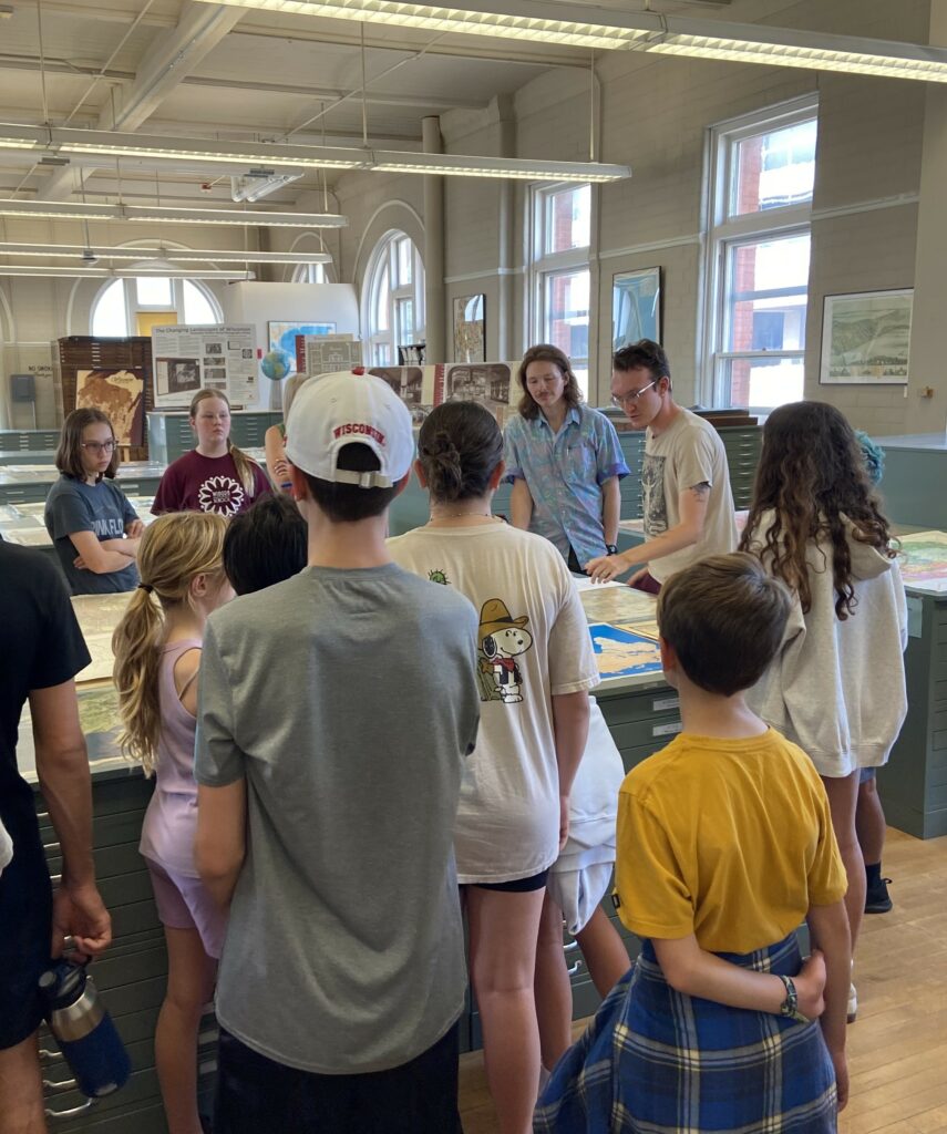 Middle schoolers stand in the Robinson Map Library