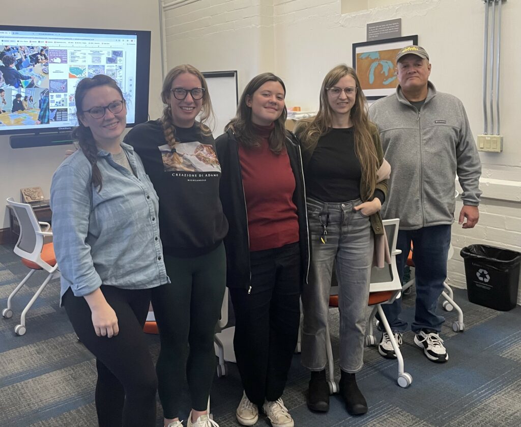 Five students pose together in the Cart Lab