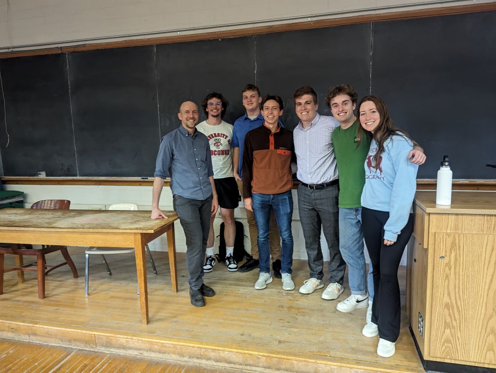 Ben Cramer stands with classmates near a podium