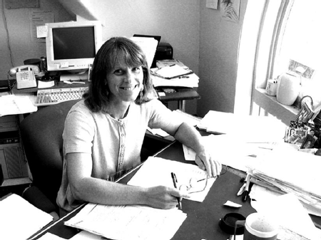 Jue Leimer sits at a desk