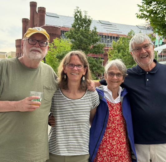 Matthew Edney (project director), Jude Leimer (managing editor), Roz Woodward (David Woodward's widow), and Roger Kain (volume 5 editor) stand together at the Memorial Union Terrace