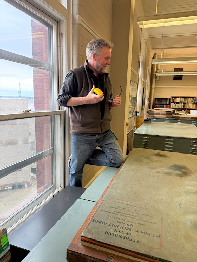 State Cartographer Howard Veregin examines a relief map
