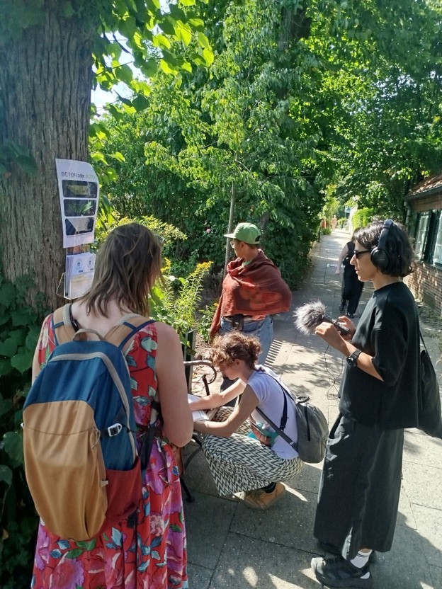 A group of cartographers gather around a tree and write their observations