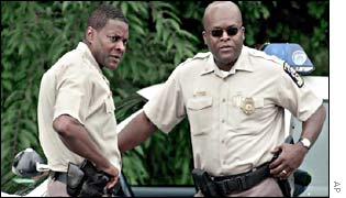 Montgomery County Chief of Police Charles Moose (left) confers with a colleague