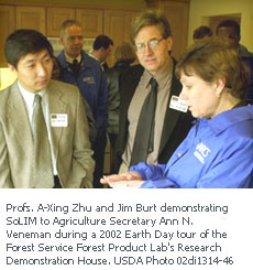 Profs. A-Xing Zhu and Jim Burt demonstrating SoLIM to Agriculture Secretary Ann N. Veneman during a 2002 Earth Day tour of the Forest Service Forest Product Lab's Research  Demonstration House. USDA Photo 02di1314-46